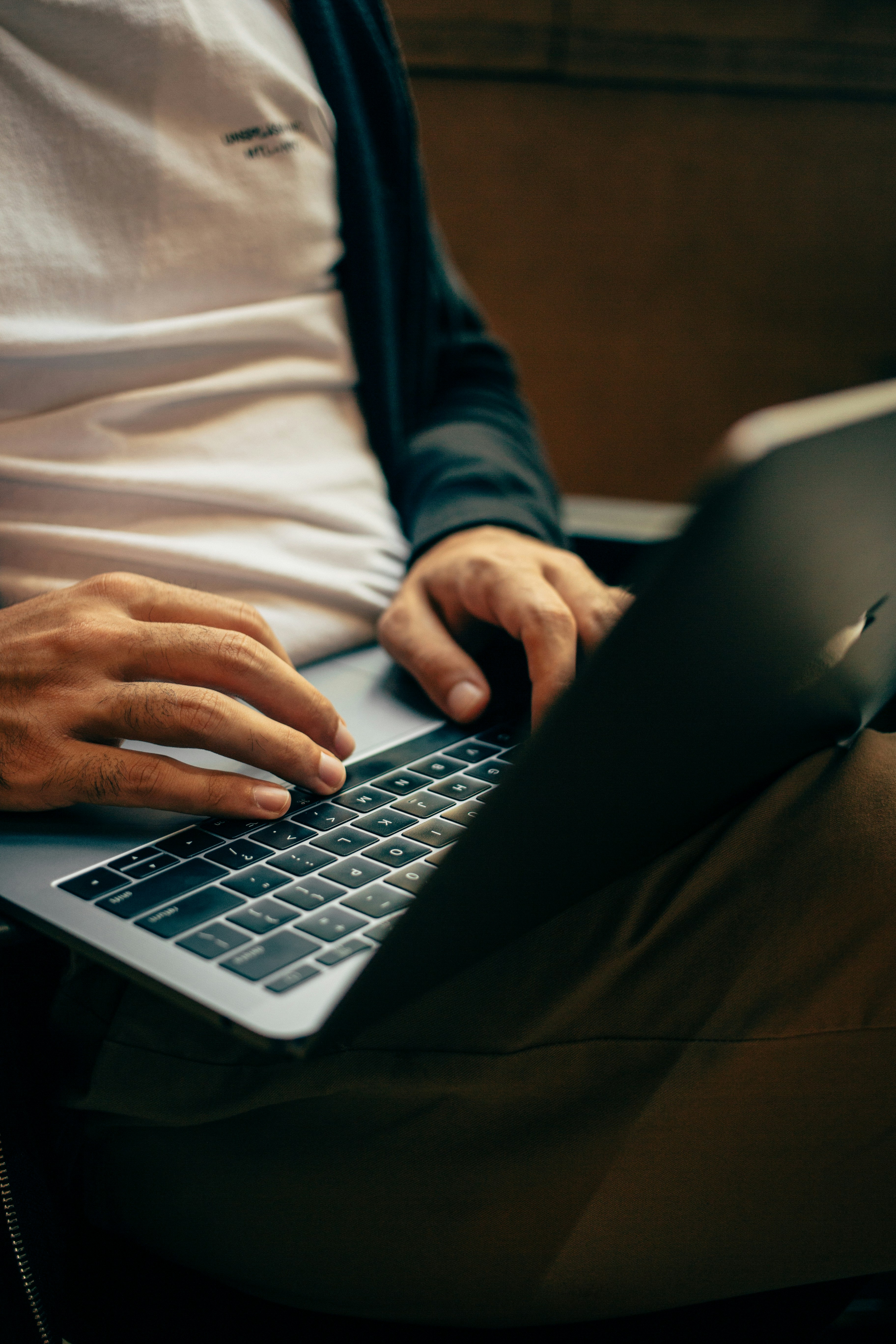 Hands typing on a laptop.